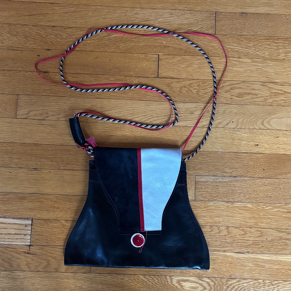 Elegant Black and White Crossbody Bag with Red Accents